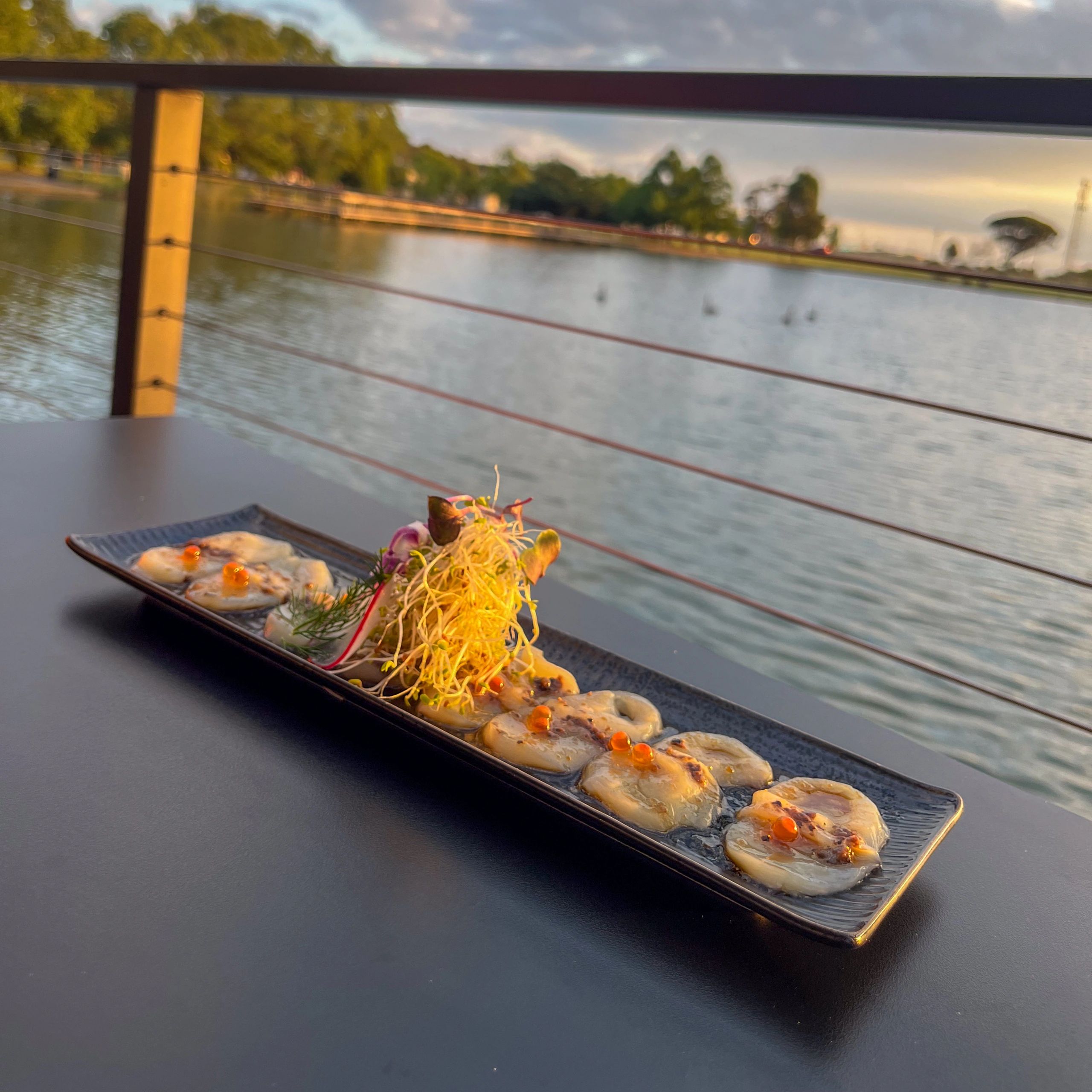 Artfully plated seafood appetizer with sprouts and roe